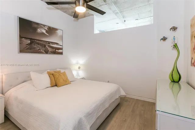 a bedroom with a bed and a painting on the wall