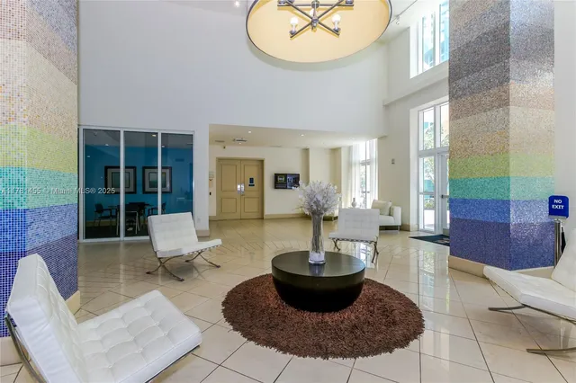 a living room with furniture a rug and a large window