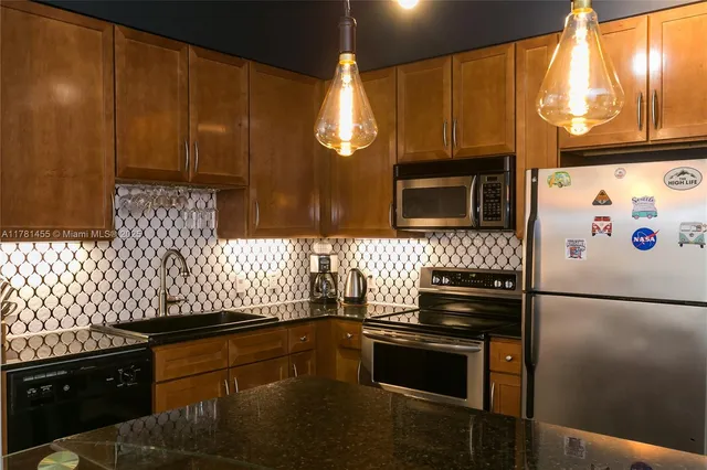 a kitchen with granite countertop cabinets and steel stainless steel appliances
