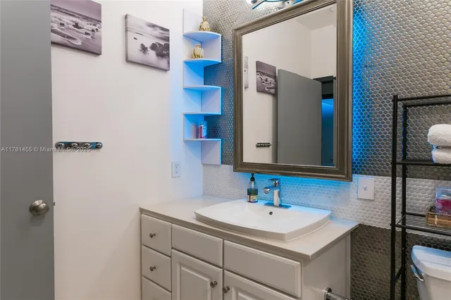 a bathroom with a sink toilet and mirror