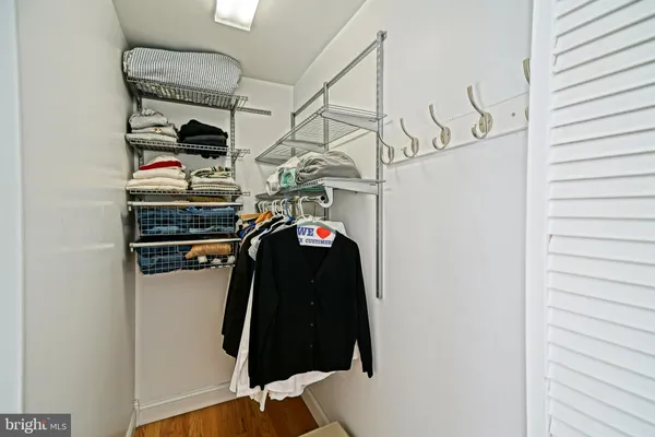 a bedroom with a bed and a flat tv screen on the dresser