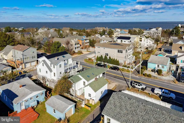 an aerial view of a house with a ocean view