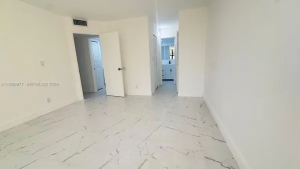 an empty room with windows and entrance