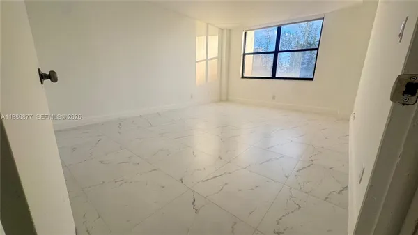 an empty room with windows and entrance