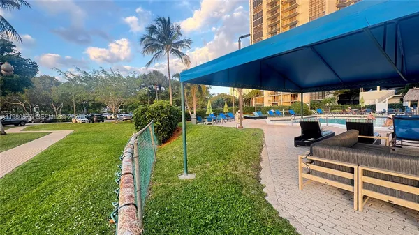 a living room with fireplace furniture and a potted plant