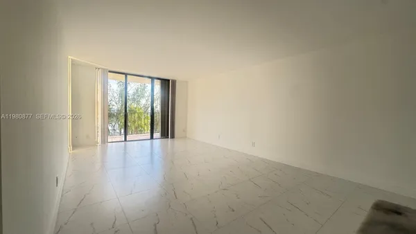 a view of an empty room with glass door
