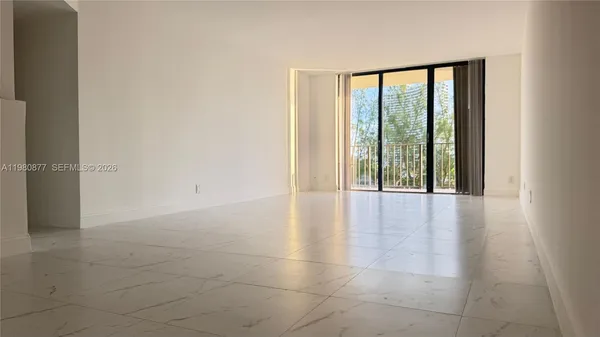 a view of an empty room with glass door