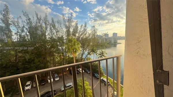 a view of a balcony with wooden fence and floor