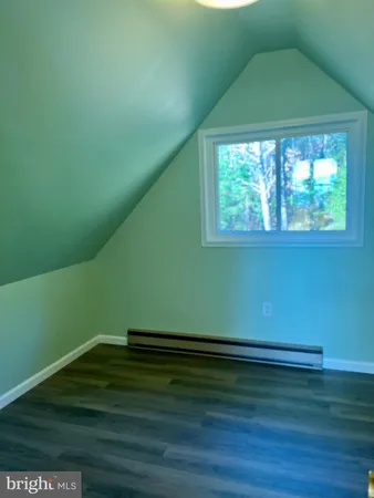 a view of room with window and hardwood