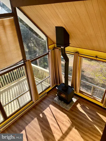 a living room with a fireplace furniture and a large window