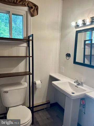a bathroom with a toilet a sink and a shower