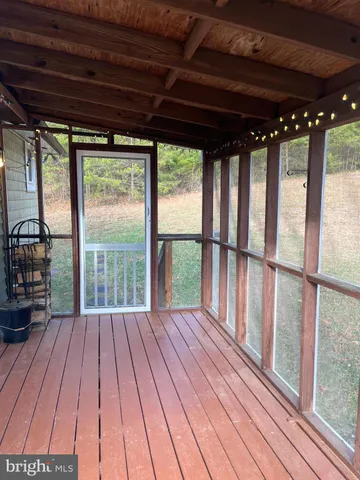 a view of balcony with wooden floor and fence