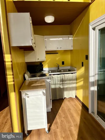 a kitchen with a sink a stove and cabinets