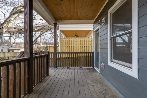 a view of a porch with wooden floor and furniture