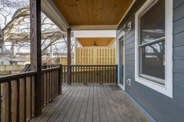 a view of a porch with wooden floor and furniture