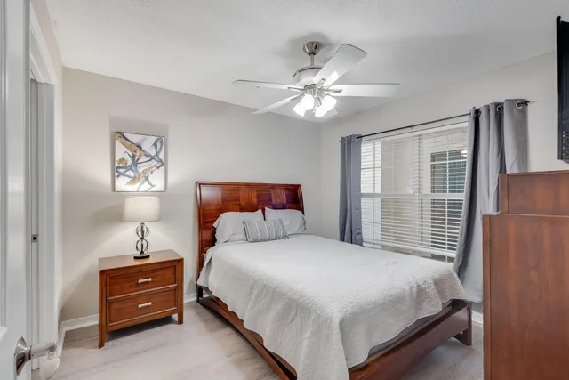 a bedroom with a bed and a lamp