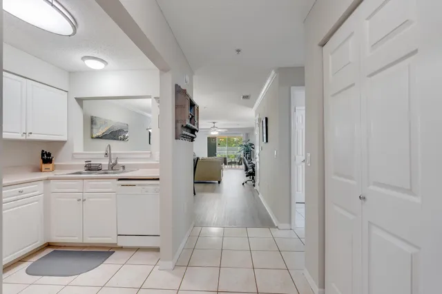 a bedroom with a bed flat screen tv and a large window