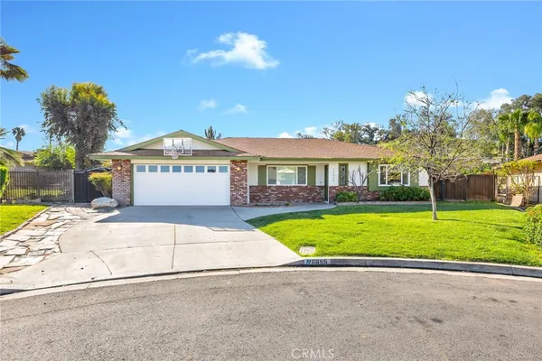 a view of yellow house with a swimming pool