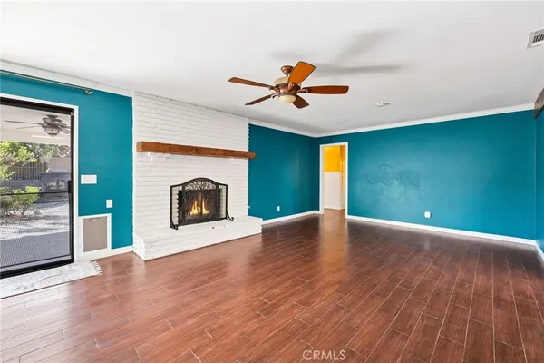 a kitchen with stainless steel appliances granite countertop a refrigerator a sink dishwasher a stove and a dining table with wooden floor