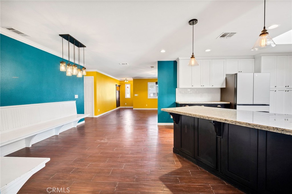 26655 Del Rosa Drive Hemet, CA 92544 - Photo 15 of 57 a view of a kitchen with kitchen island a sink wooden floor and a large window