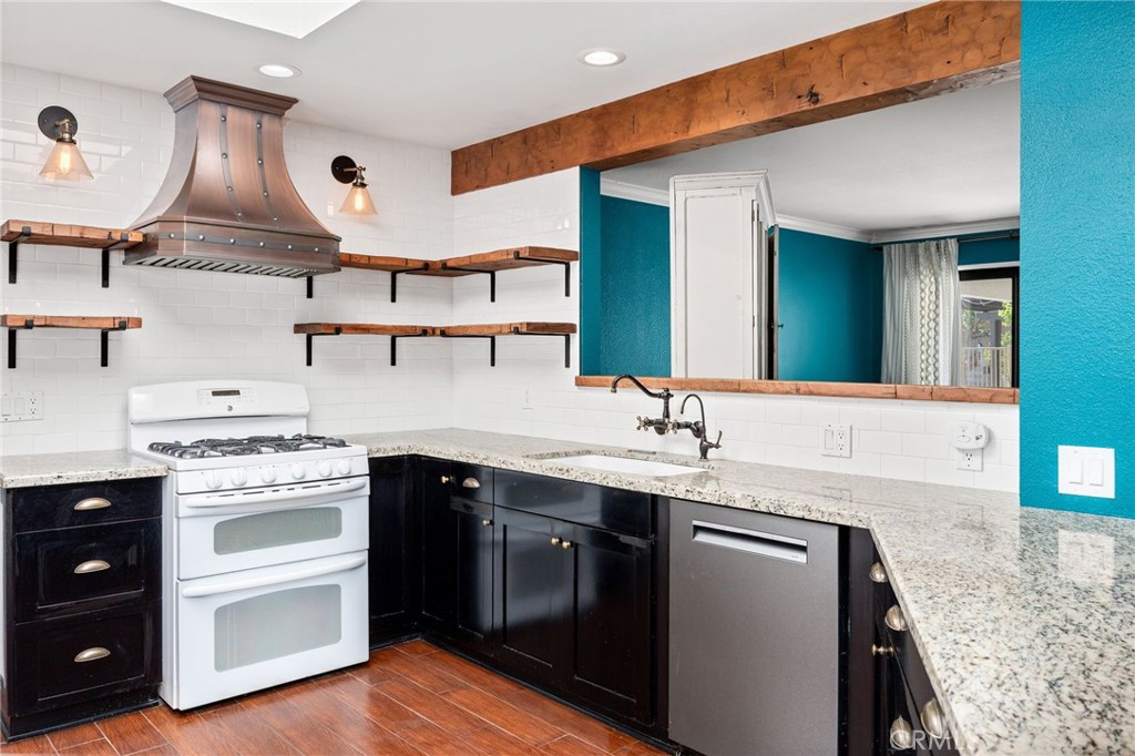 26655 Del Rosa Drive Hemet, CA 92544 - Photo 17 of 57 a kitchen with a sink and a stove