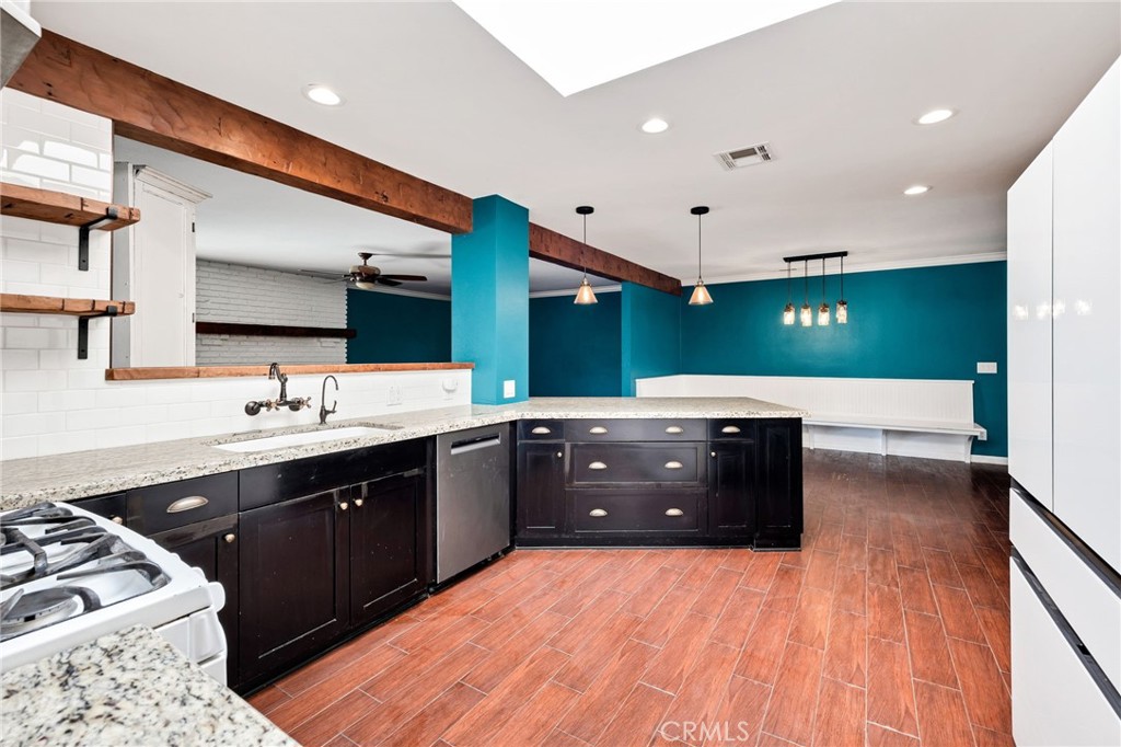 26655 Del Rosa Drive Hemet, CA 92544 - Photo 18 of 57 a kitchen with a sink and a stove top oven