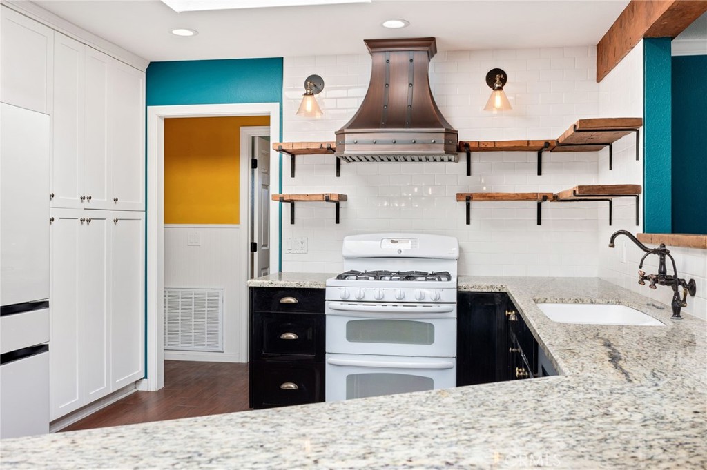 26655 Del Rosa Drive Hemet, CA 92544 - Photo 19 of 57 a kitchen with a stove and a sink