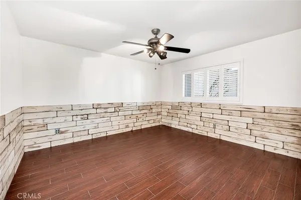 a bathroom with a granite countertop sink a mirror and shower
