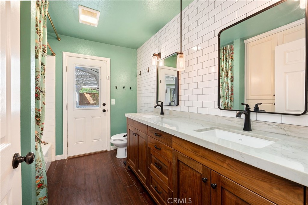 26655 Del Rosa Drive Hemet, CA 92544 - Photo 21 of 57 a spacious bathroom with a double vanity sink and a mirror