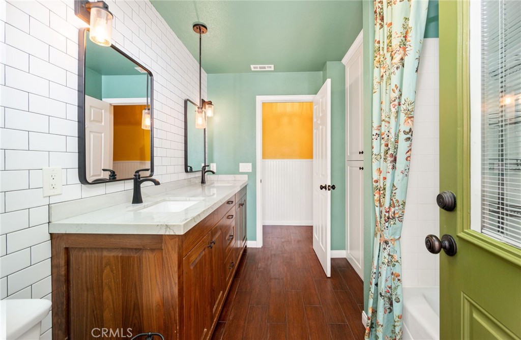 26655 Del Rosa Drive Hemet, CA 92544 - Photo 22 of 57 a bathroom with a granite countertop sink a mirror and shower