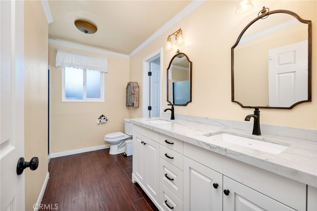 26655 Del Rosa Drive Hemet, CA 92544 - Photo 27 of 57 a bathroom with a granite countertop toilet sink and mirror
