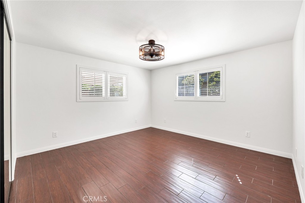 26655 Del Rosa Drive Hemet, CA 92544 - Photo 29 of 57 an empty room with wooden floor and windows