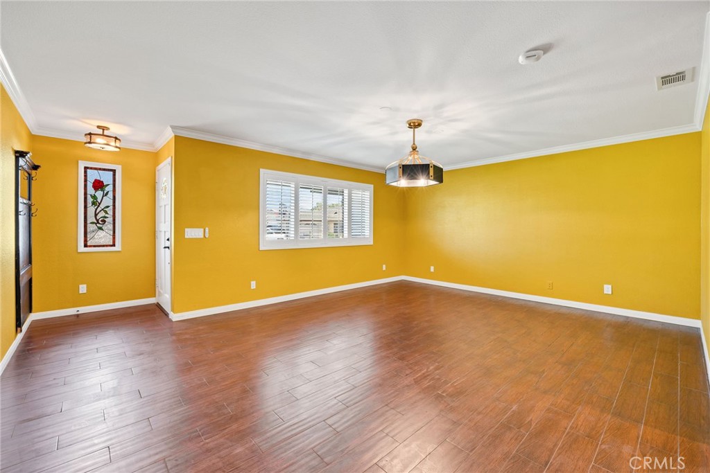 26655 Del Rosa Drive Hemet, CA 92544 - Photo 5 of 57 a view of an empty room with wooden floor and a window