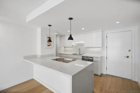 a kitchen with a sink stove and refrigerator