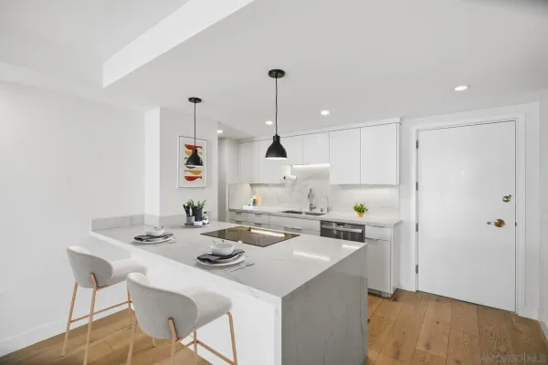 a kitchen with a sink a stove a refrigerator and white cabinets