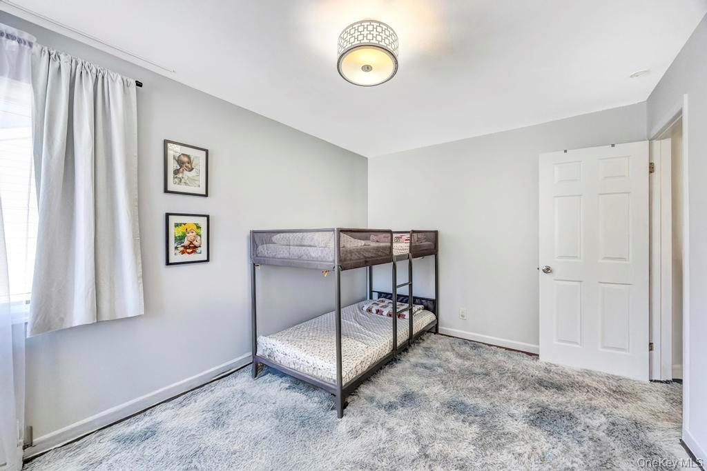 179 Sterling Road Elmont, NY 11003 - Photo 17 of 20 Carpeted bedroom featuring baseboards