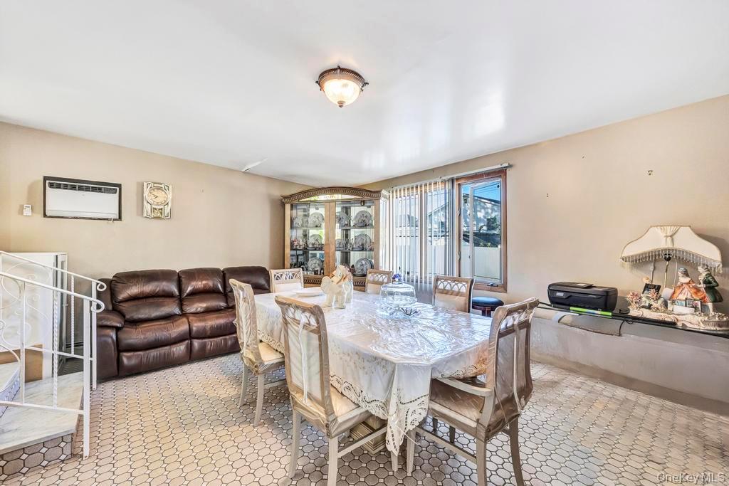179 Sterling Road Elmont, NY 11003 - Photo 10 of 20 Dining space featuring a wall unit AC