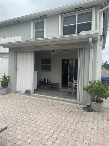 a front view of a house with sitting area