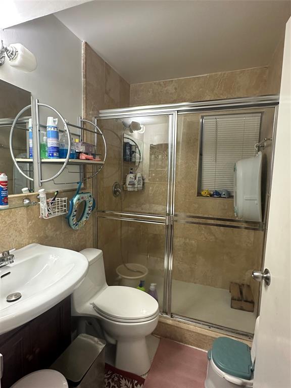 4753 Southwest 154th Court Miami, FL 33185 - Photo 25 of 30 a bathroom with a sink toilet and shower