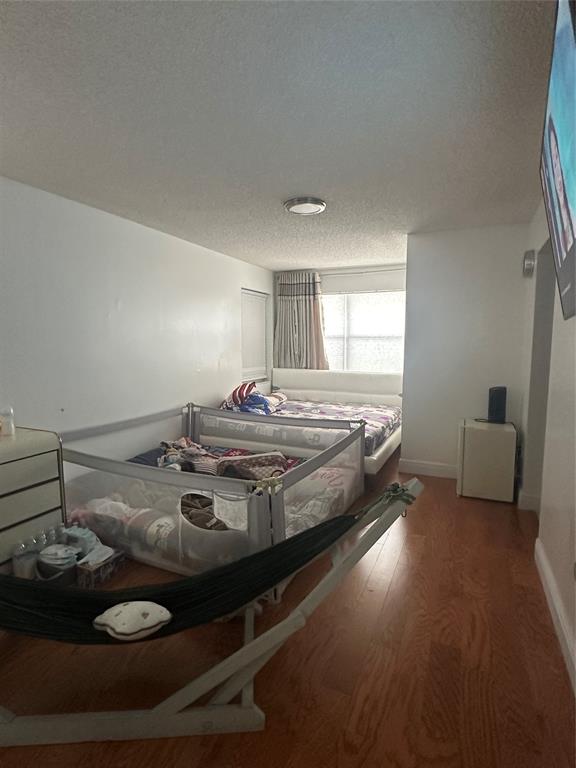 4753 Southwest 154th Court Miami, FL 33185 - Photo 28 of 30 a bed sitting in a bedroom next to a window