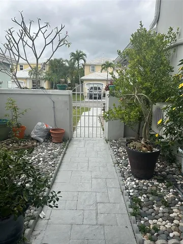 a view of a patio with chair and tables back yard of the house