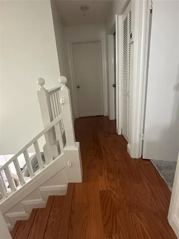 a view of an entryway with wooden floor