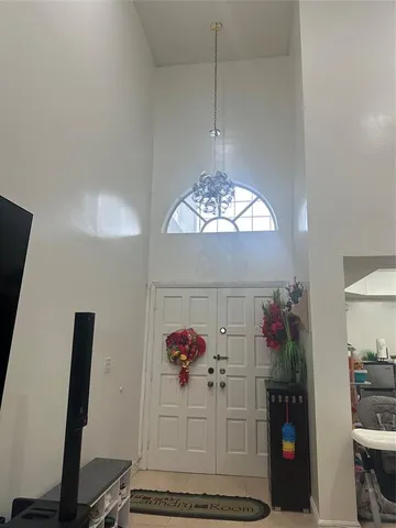 a view of a dining room with furniture and chandelier