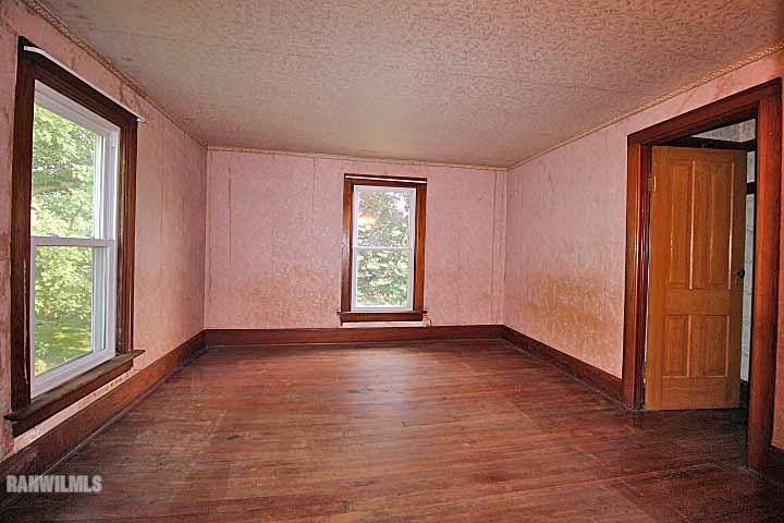 5347 West Richland Road Freeport, IL 61032 - Photo 12 of 20 an empty room with wooden floor and windows