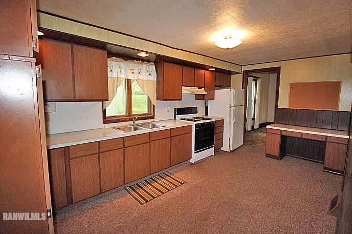 5347 West Richland Road Freeport, IL 61032 - Photo 17 of 20 a kitchen with stainless steel appliances a stove and a refrigerator