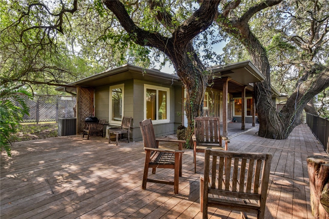 a view of a wooden chairs and a tree in the patio