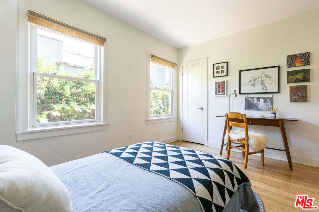 3407 Madera Avenue Los Angeles, CA 90039 - Photo 17 of 46 a bedroom with a bed and wooden floor