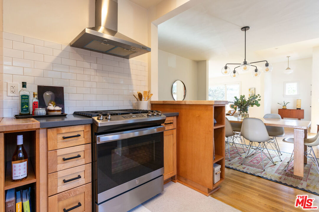 3407 Madera Avenue Los Angeles, CA 90039 - Photo 20 of 46 a kitchen with stainless steel appliances a stove a table and chairs