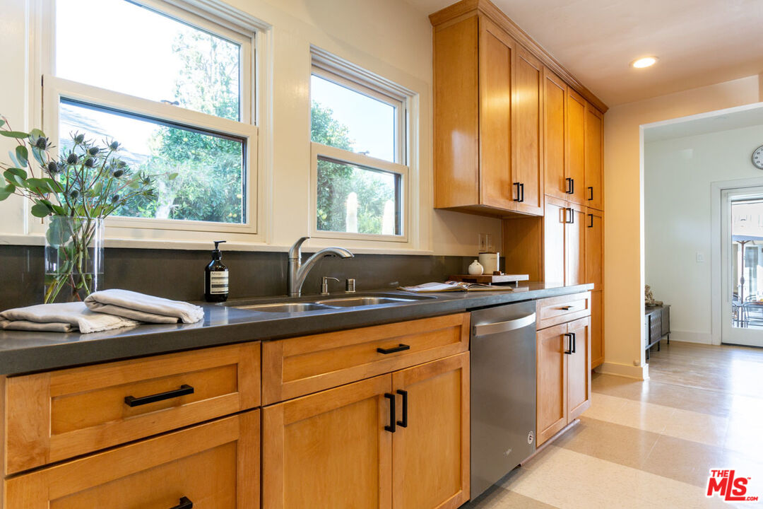 3407 Madera Avenue Los Angeles, CA 90039 - Photo 21 of 46 a kitchen with stainless steel appliances granite countertop white cabinets and a window