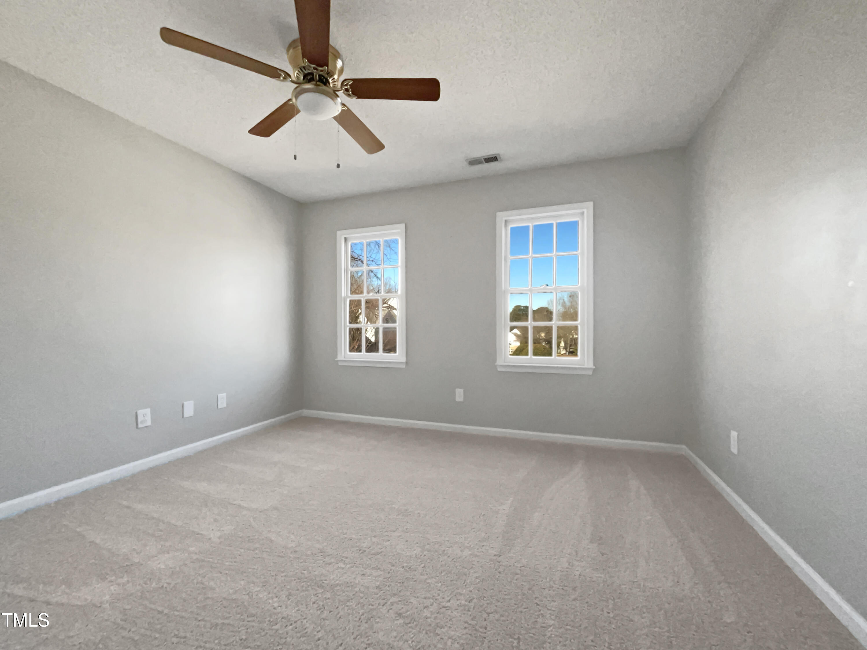 118 Trafalgar Lane Cary, NC 27513 - Photo 14 of 22 an empty room with windows and fan